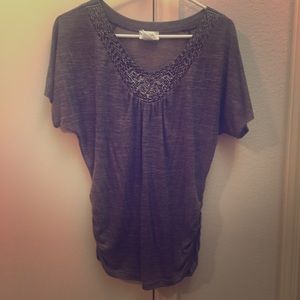 Brown top with sequin neckline.